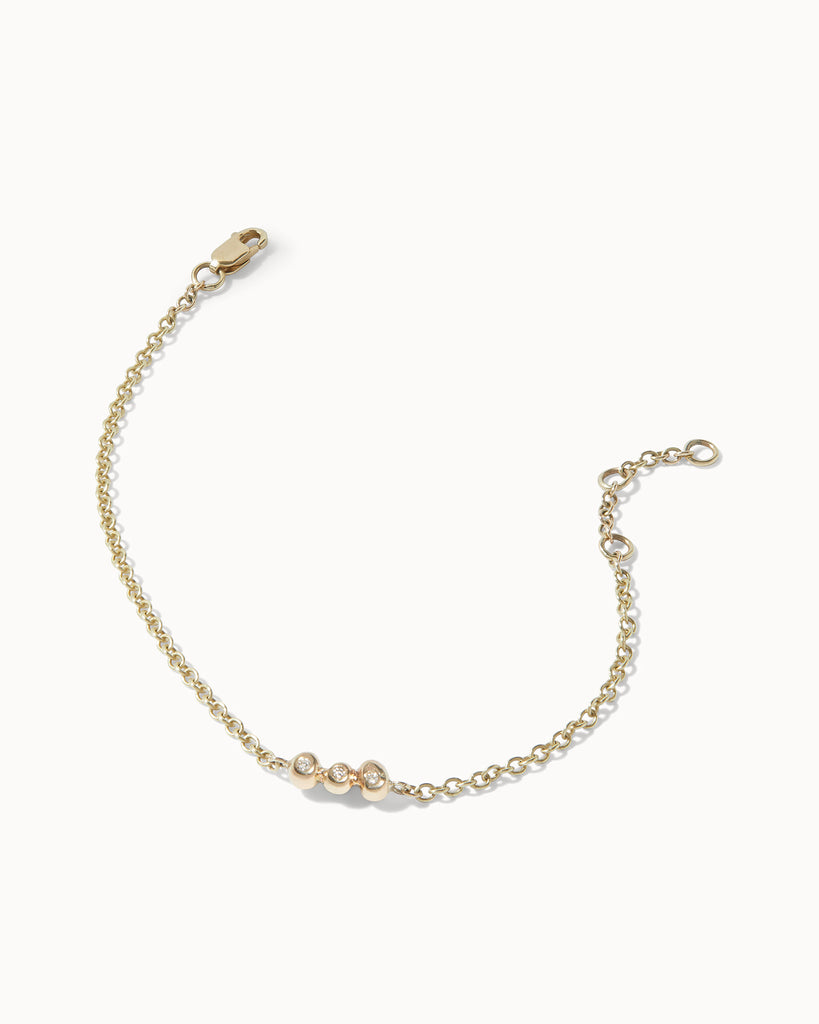 Recycled yellow gold chain bracelet featuring three white diamonds in bezel setting handcrafted in London by Maya Magal London