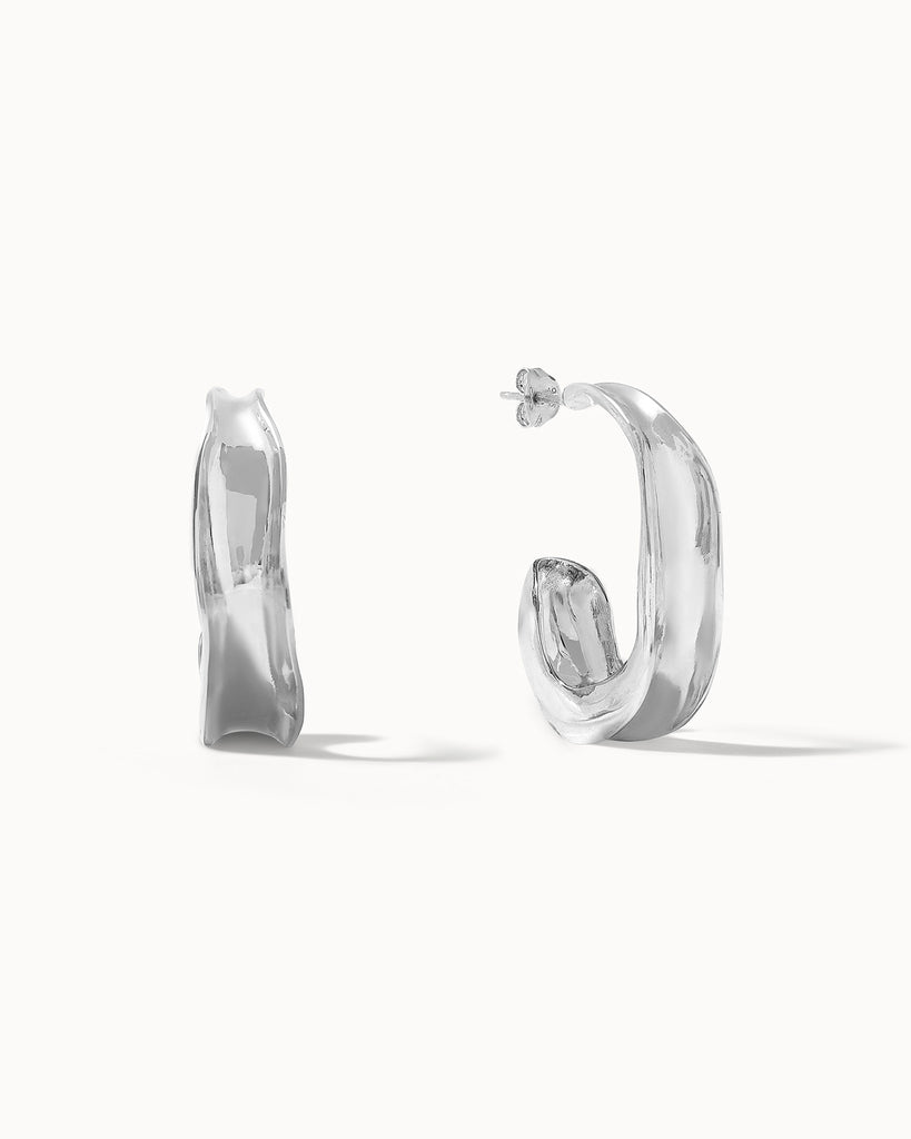 Recycled sterling silver concave sculptural hoop earrings handcrafted in London by Maya Magal London