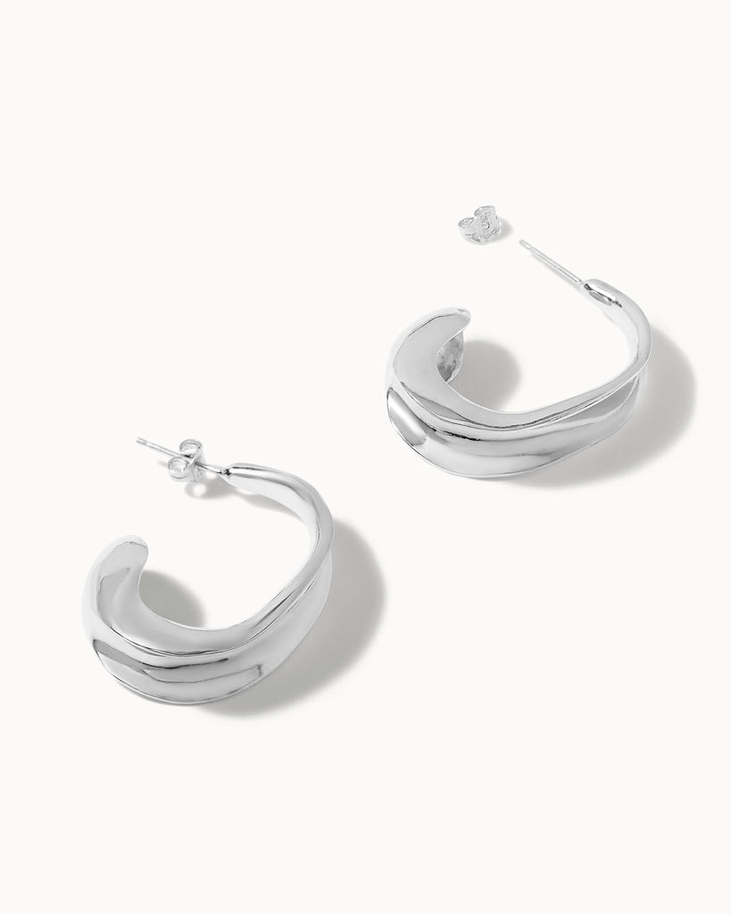 Recycled sterling silver concave sculptural hoop earrings handcrafted in London by Maya Magal London