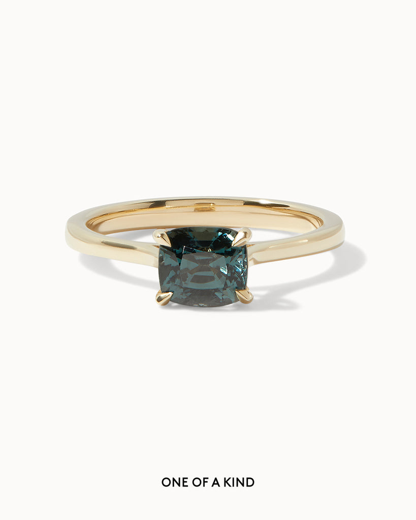 solid gold solitaire engagement ring featuring an oval blue spinel handcrafted in London by Maya Magal London