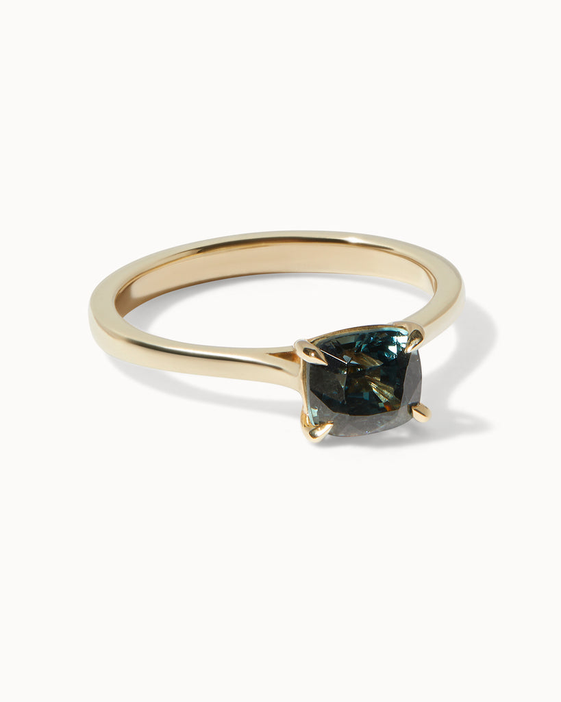 solid gold solitaire engagement ring featuring an oval blue spinel handcrafted in London by Maya Magal London