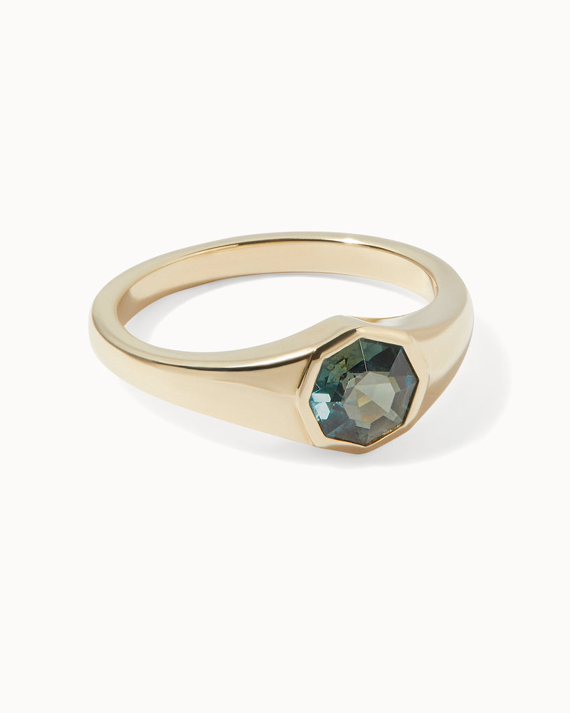 Solid gold engagement ring featuring an octagonal sapphire in bezel setting by Maya Magal London