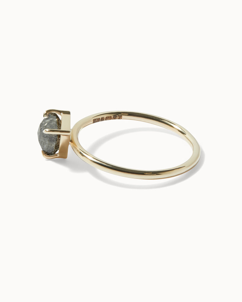 solid gold solitaire engagement ring featuring a trillion cut grey diamond handcrafted in London by Maya Magal London