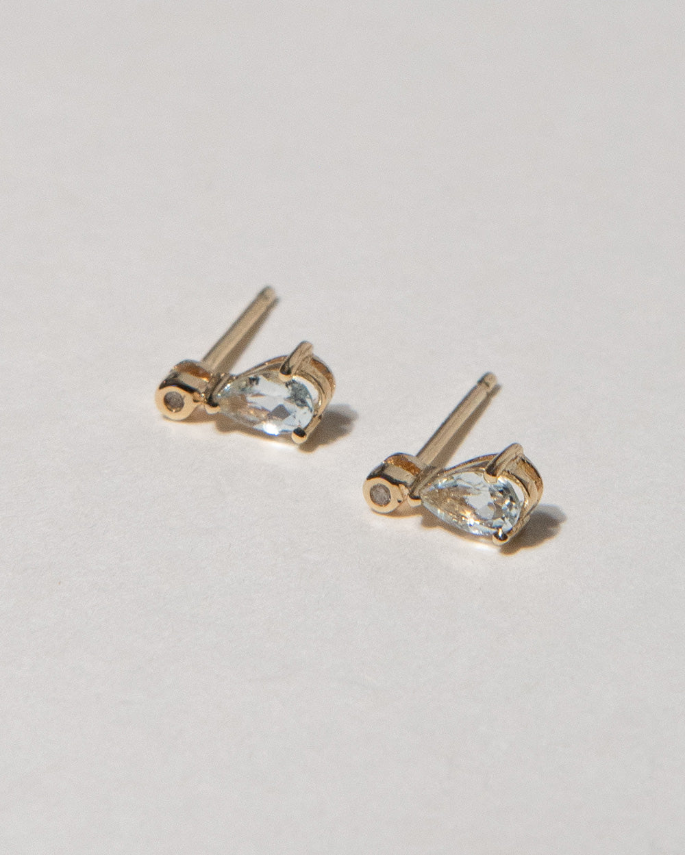 Aquamarine and Diamond Pear Drop Earrings 9 ct gold  on white background side view 