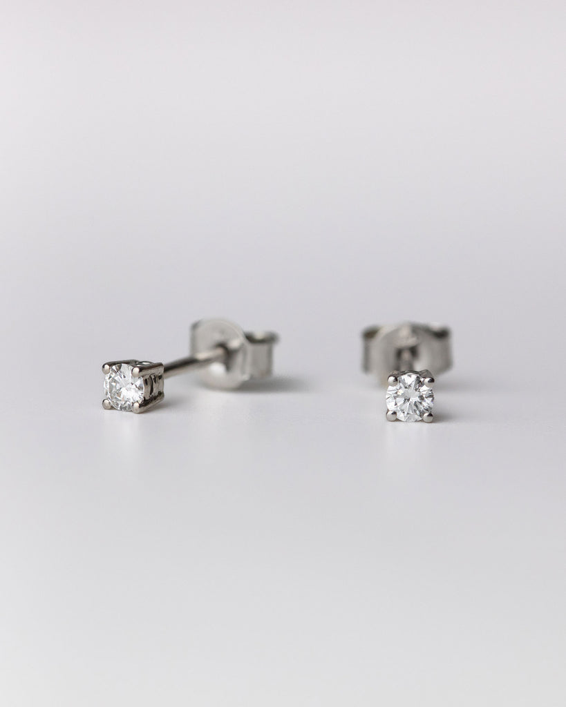 Round cut diamond stud earrings set in recycled 9ct solid white gold handcrafted in London by Maya Magal London