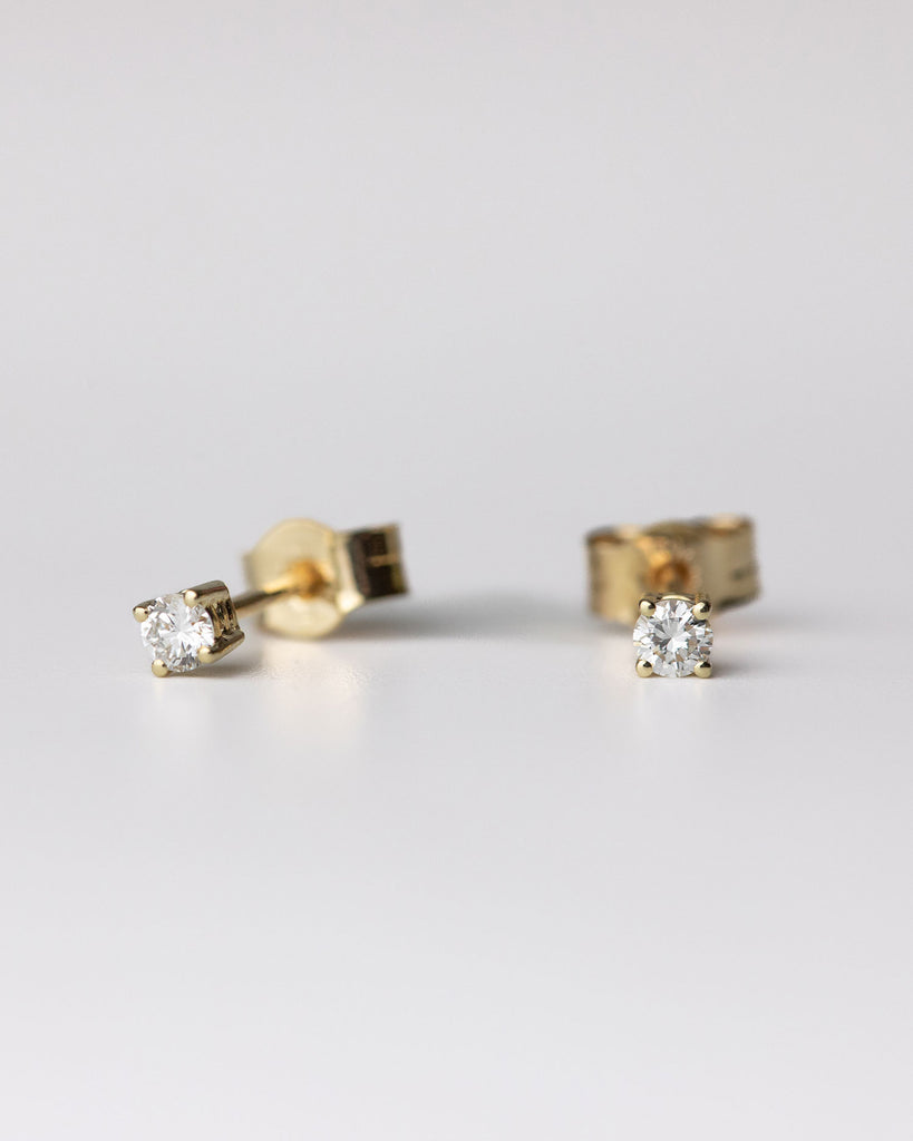 Round cut diamond stud earrings set in recycled 9ct solid yellow gold handcrafted in London by Maya Magal London