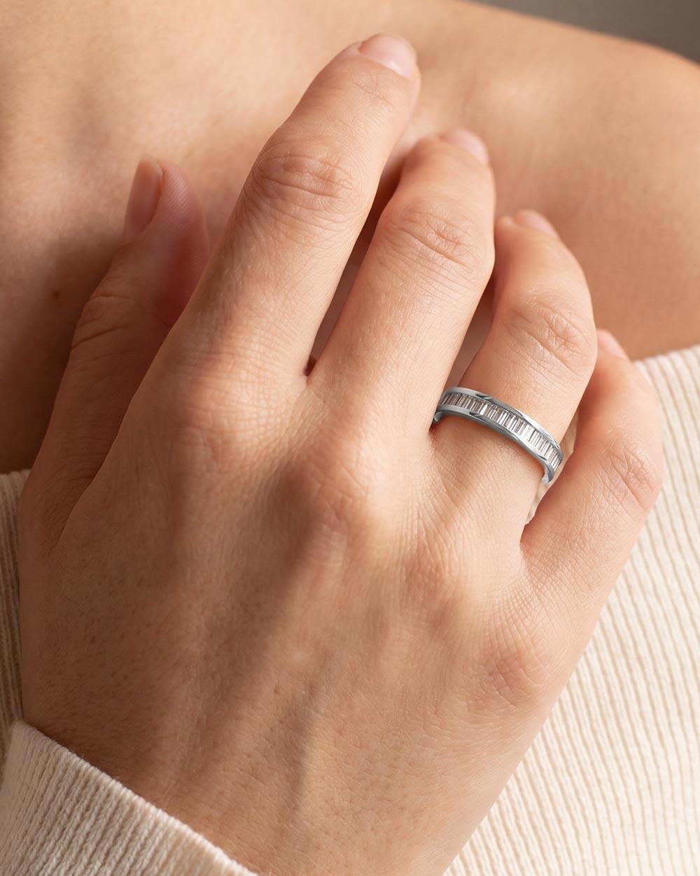 Model wearing Platinum Baguette Diamond Channel Ring. 