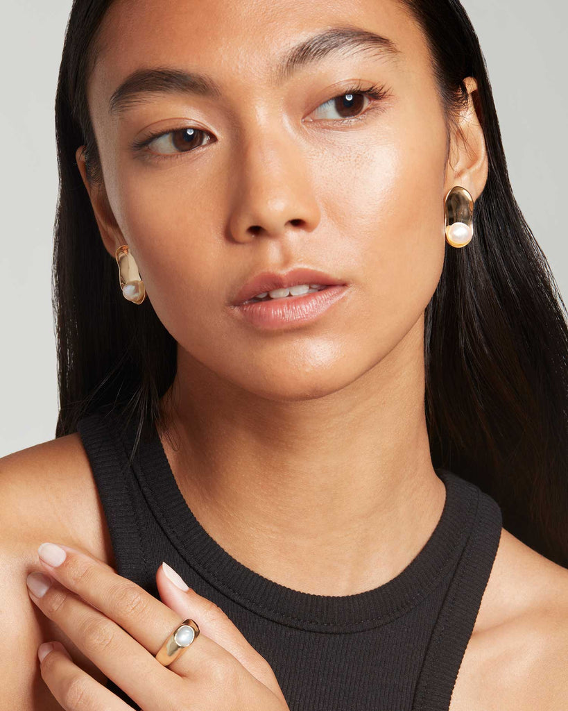 Model wears Baroque pearl solid gold earrings made in London by Maya Magal