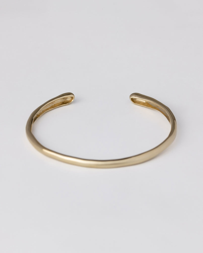 hand-carved recycled 9ct solid yellow gold bangle with finely set white and champagne natural diamonds handcrafted in London by Maya Magal London