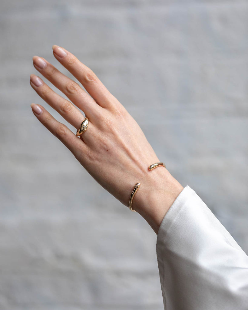 Recycled 9ct solid yellow gold sculptural signet ring with finely set white and champagne natural diamonds handcrafted in London by Maya Magal London