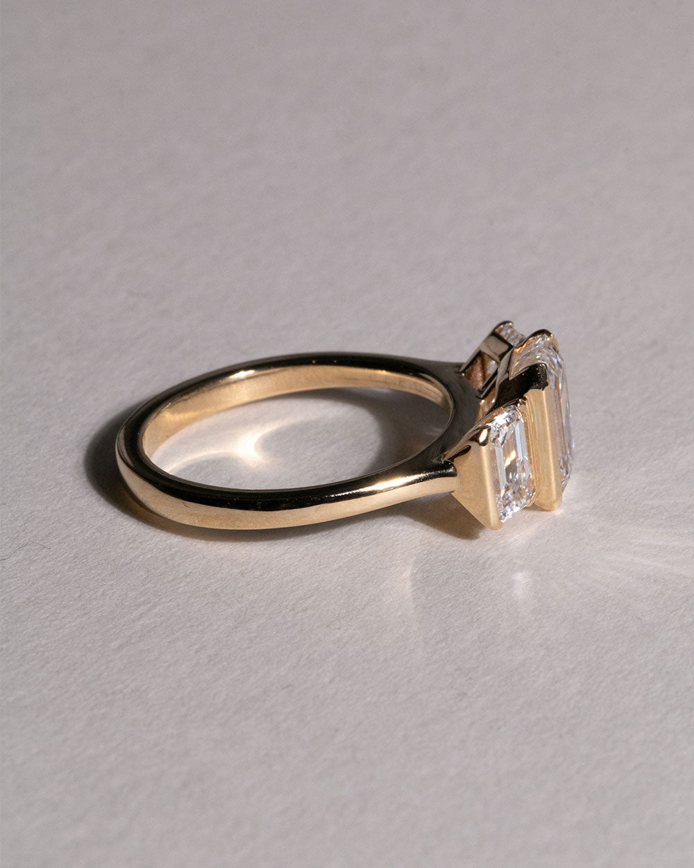 Side view of 9ct Gold 2.05ct Emerald Cut Lab Grown Diamond Trilogy Ring.