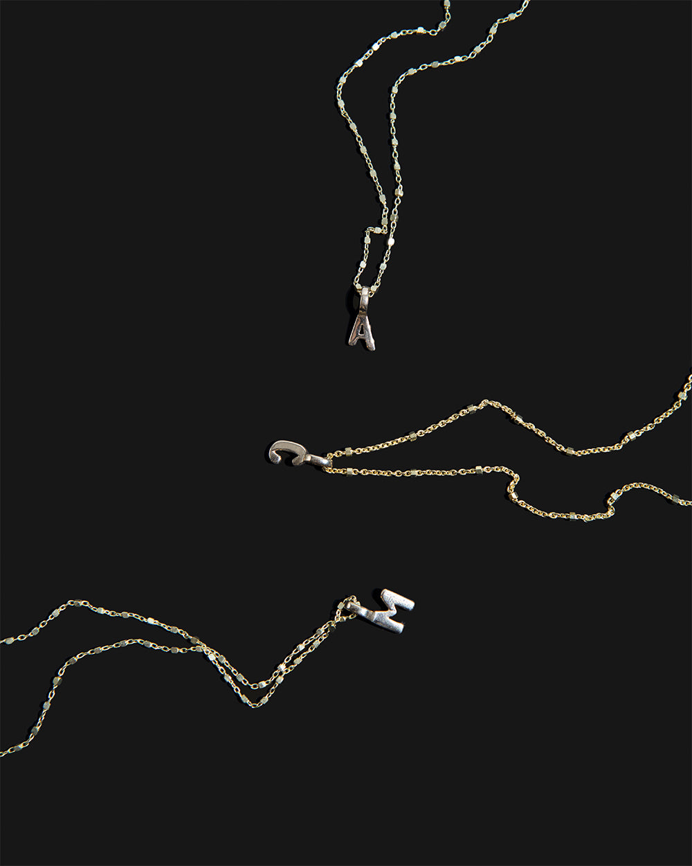 Recycled 925 sterling silver initial charm necklaces handmade in London by Maya Magal London