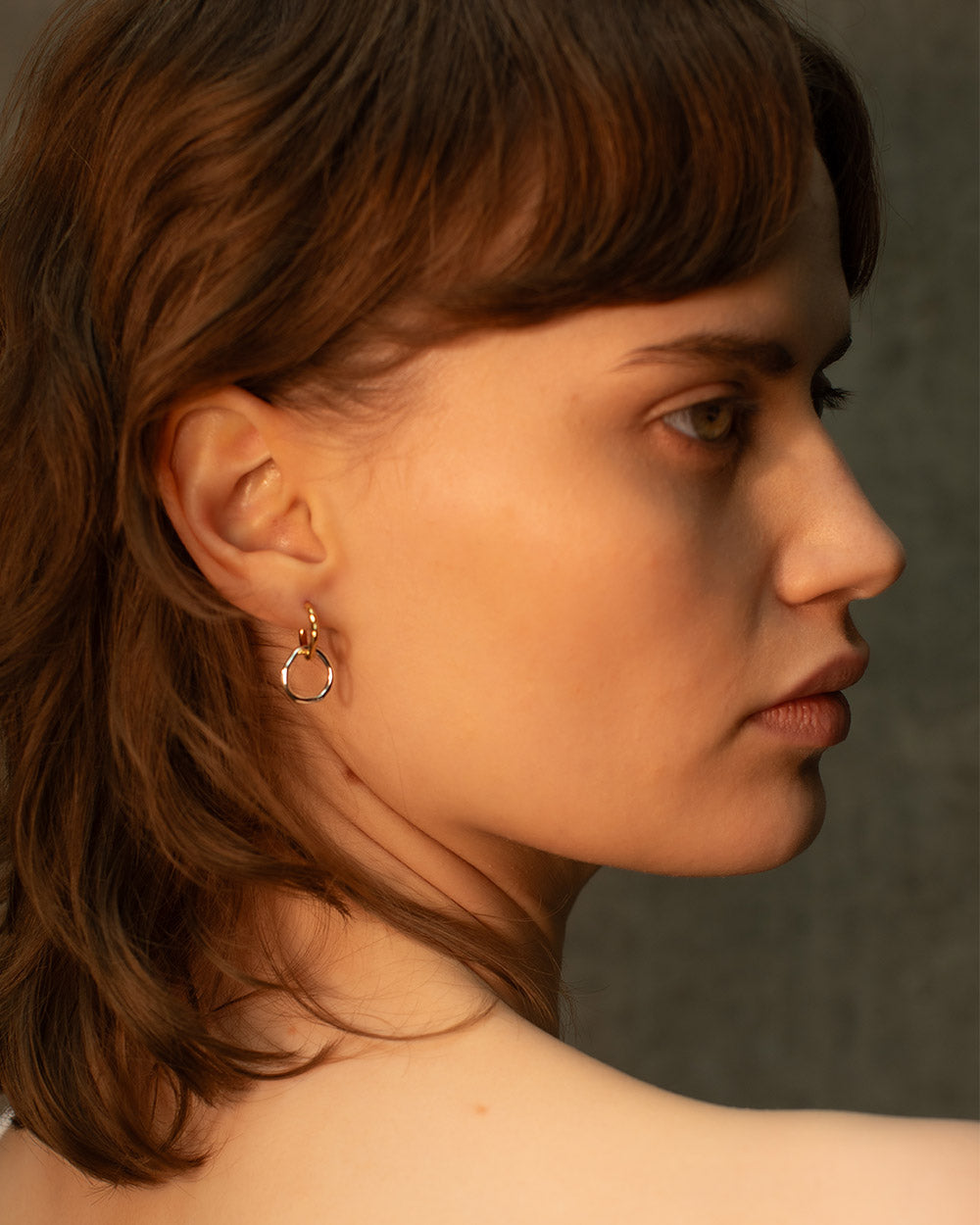 model wearing Sterling silver and 18ct gold plated interlinked hoop earrings mixed metal.