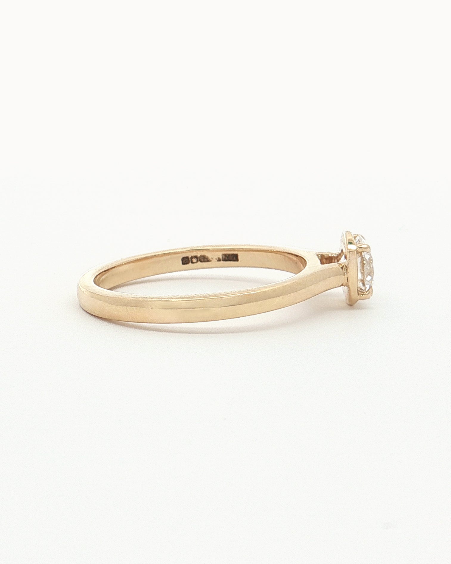 side view of 0.5ct Lab Grown Diamond Halo Ring with 9 Ct solid gold band on white background