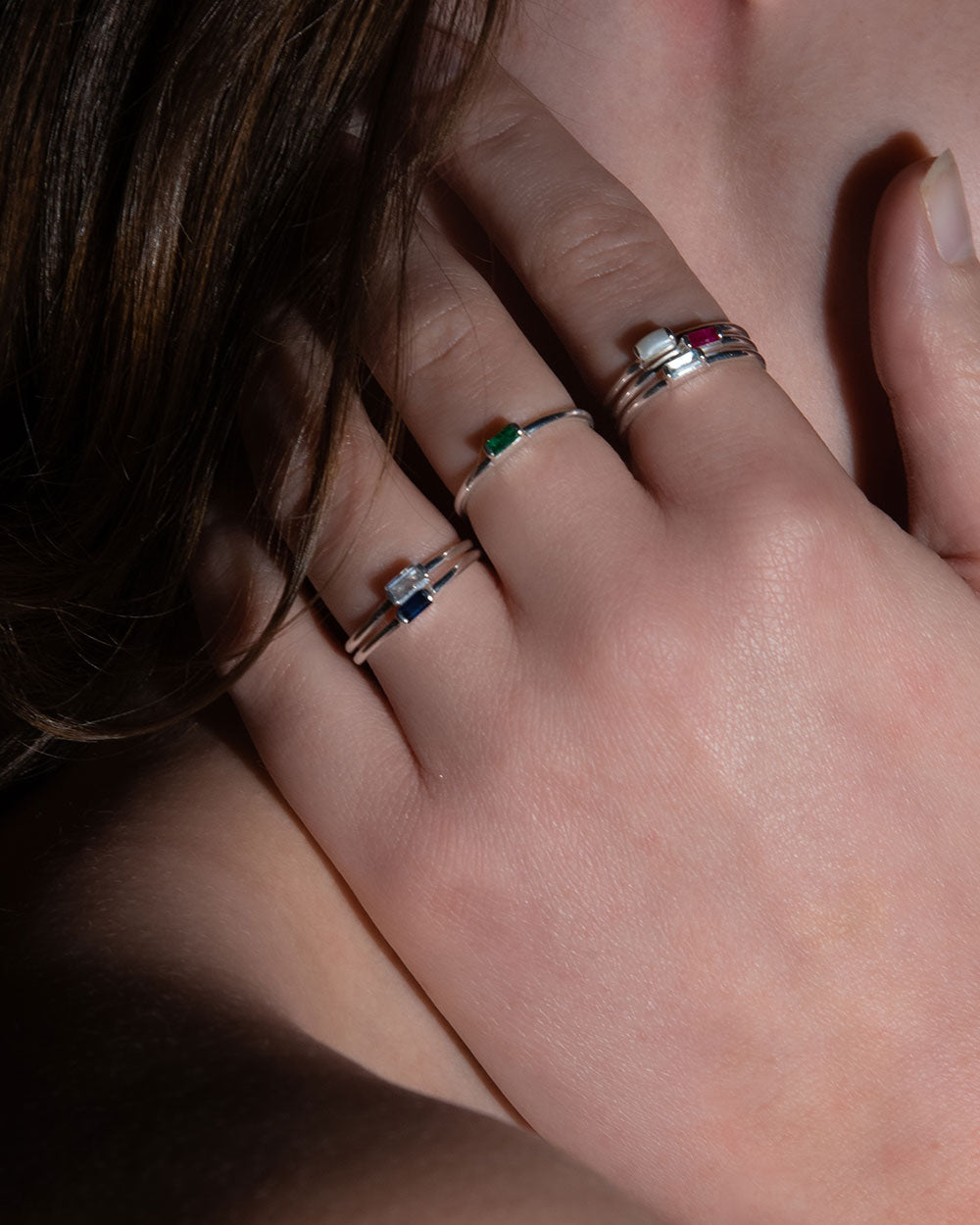 March Aquamarine Birthstone Baguette Ring displayed on model with other sterling silver birthstone rings 