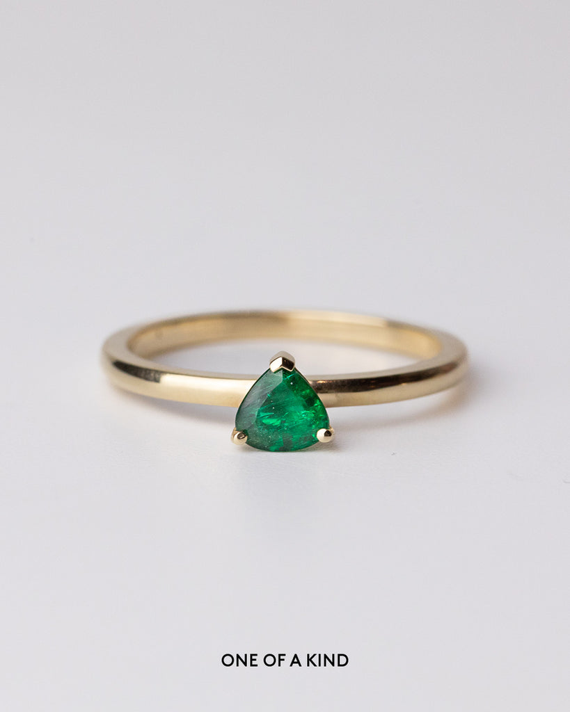 Pear cut emerald solitaire ring set in a recycled 9 ct solid yellow gold band handcrafted in London by Maya Magal
