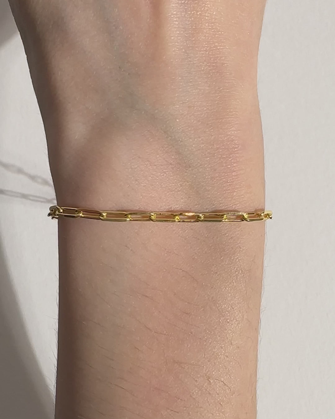 Video of model wearing 18ct gold plated paperchain on white background. Lobster clasp.