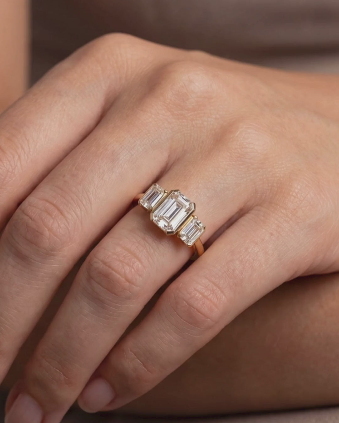 18ct Gold Emerald Cut Lab Grown Diamond Trilogy Ring on model