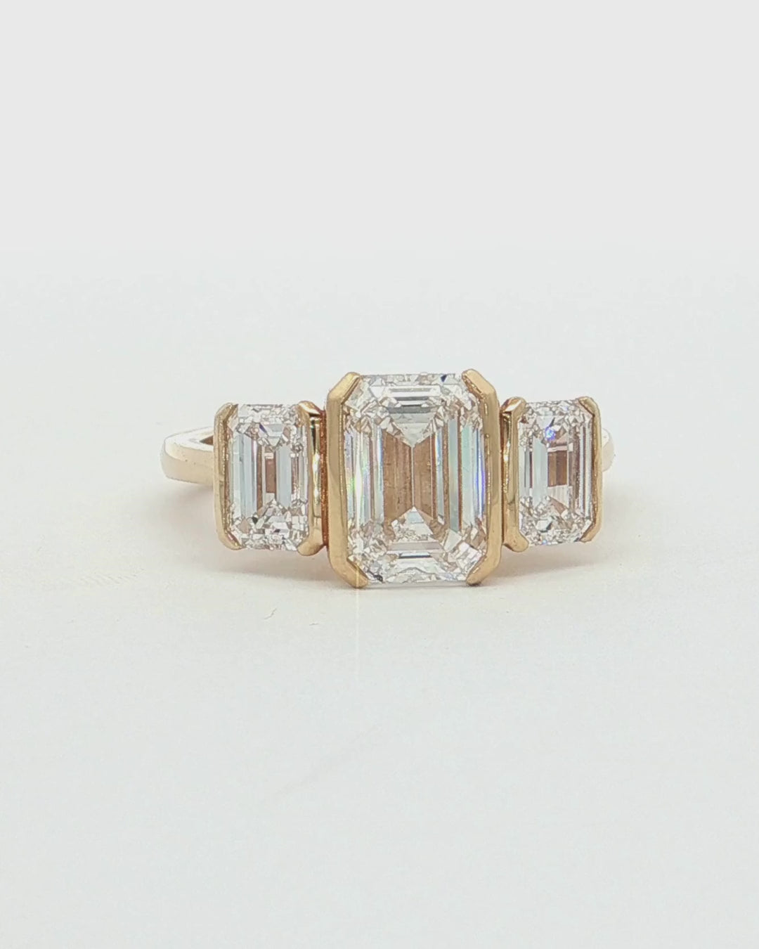 360 video of 9ct Gold 2.05ct Emerald Cut Lab Grown Diamond Trilogy Ring.