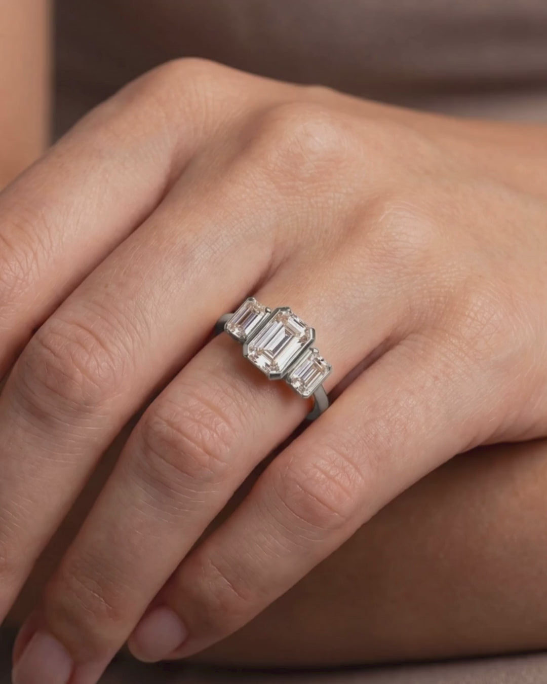 Platinum Emerald Cut Lab Grown Diamond Trilogy Ring on model