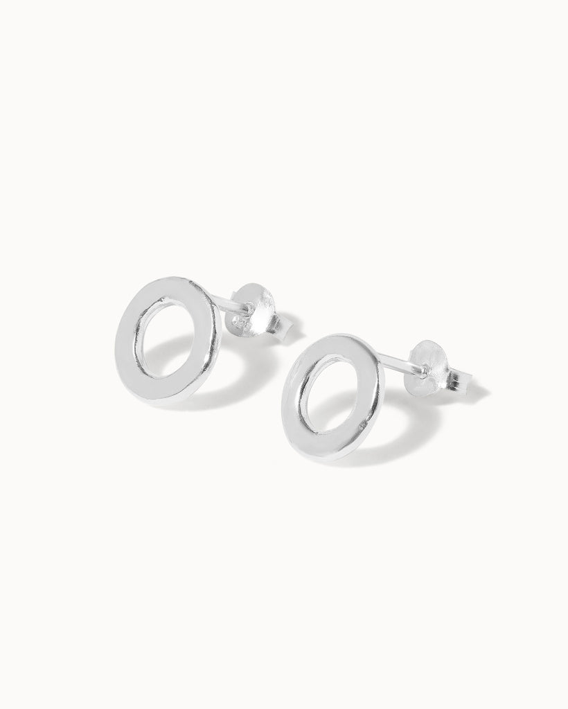 Statement sterling silver circular small stud earrings with hammered texture handcrafted in London by Maya Magal London