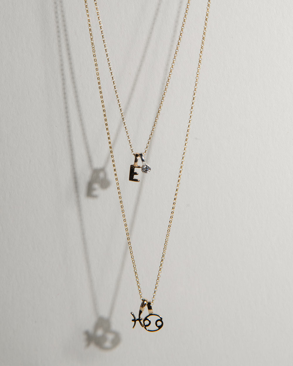2 gold necklaces with Zodiac Charms 