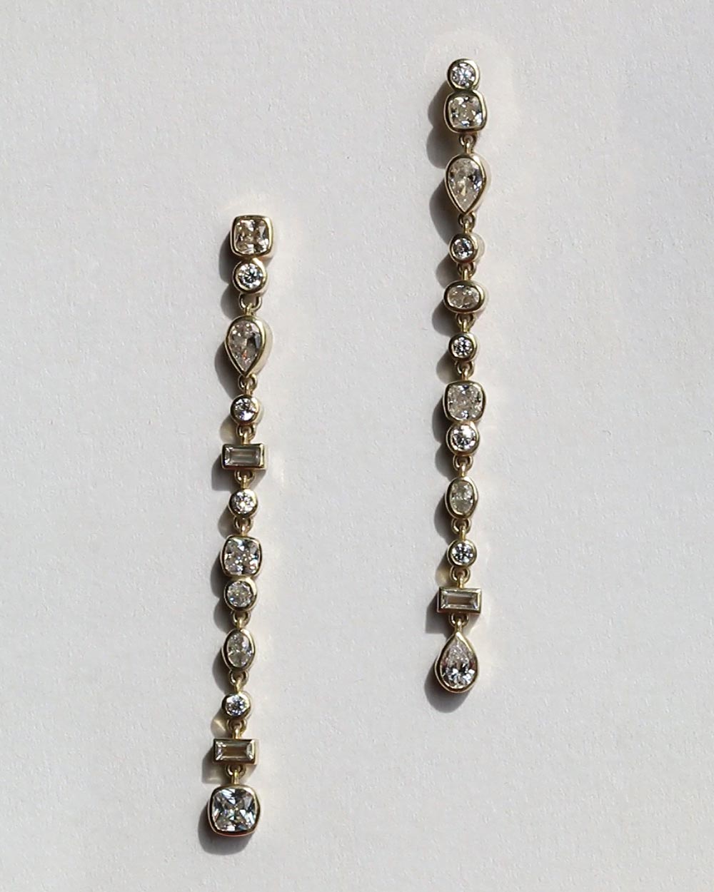 Front view of Vega Diamond Drop Earrings on white background. 
