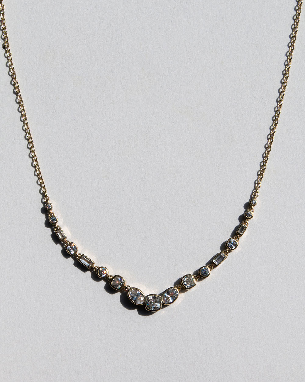 Gold Vega Diamond Necklace on white backdrop. 
