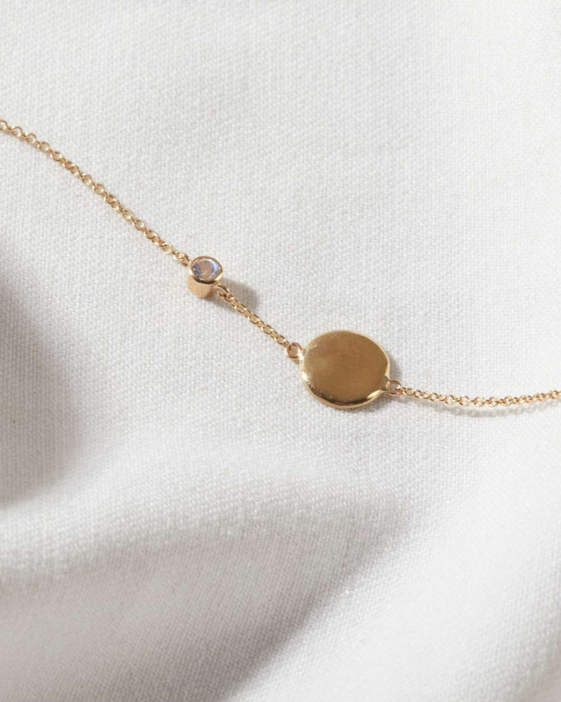 recycled 9ct solid yellow gold bracelet with circle charm and moonstone charm handcrafted in London by Maya Magal
